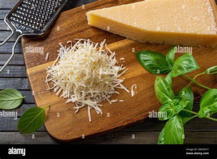 Grated cheese on a wooden board.