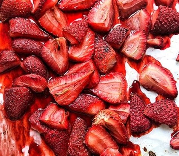 Juicy roasted strawberries in a baking dish.