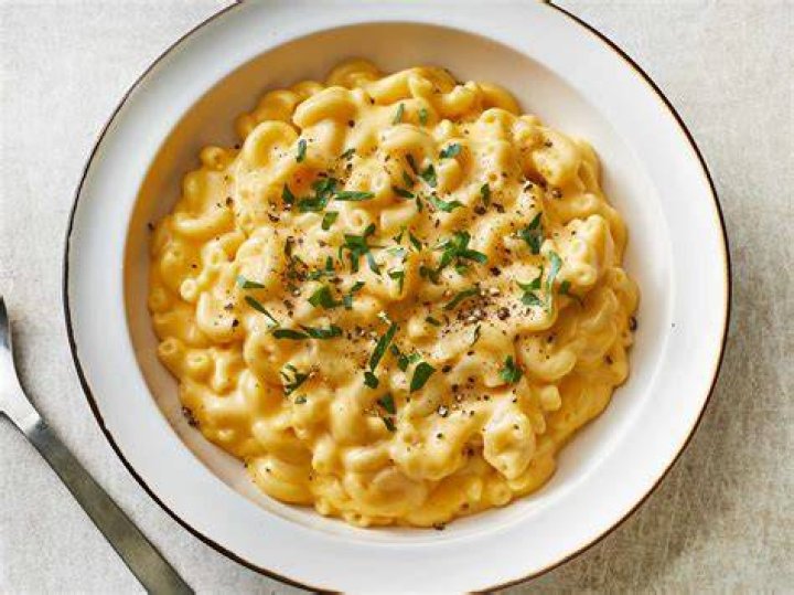 Macaroni and cheese in a skillet with a fork.