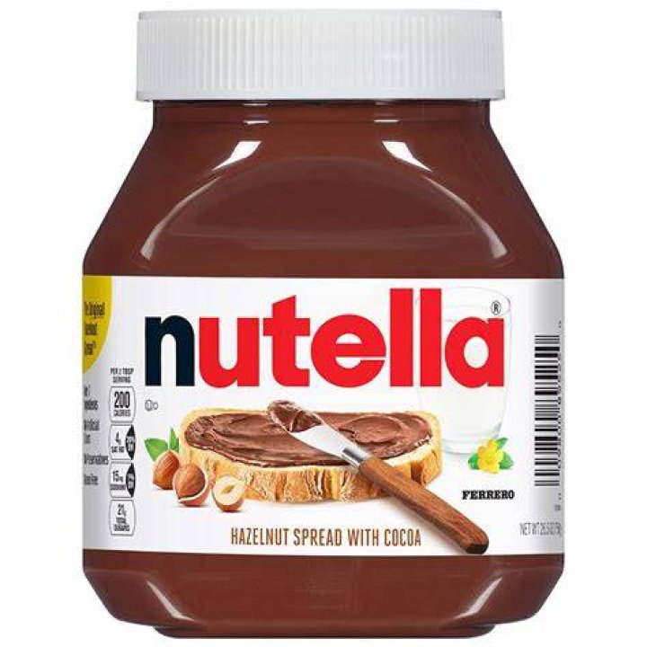 Nutella and cocoa in gold measuring cups.