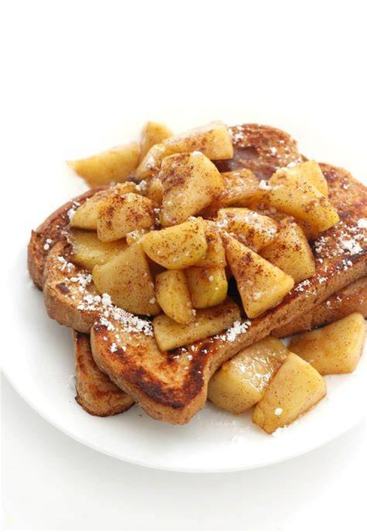 Plate of apple french toast casserole topped with whipped cream.
