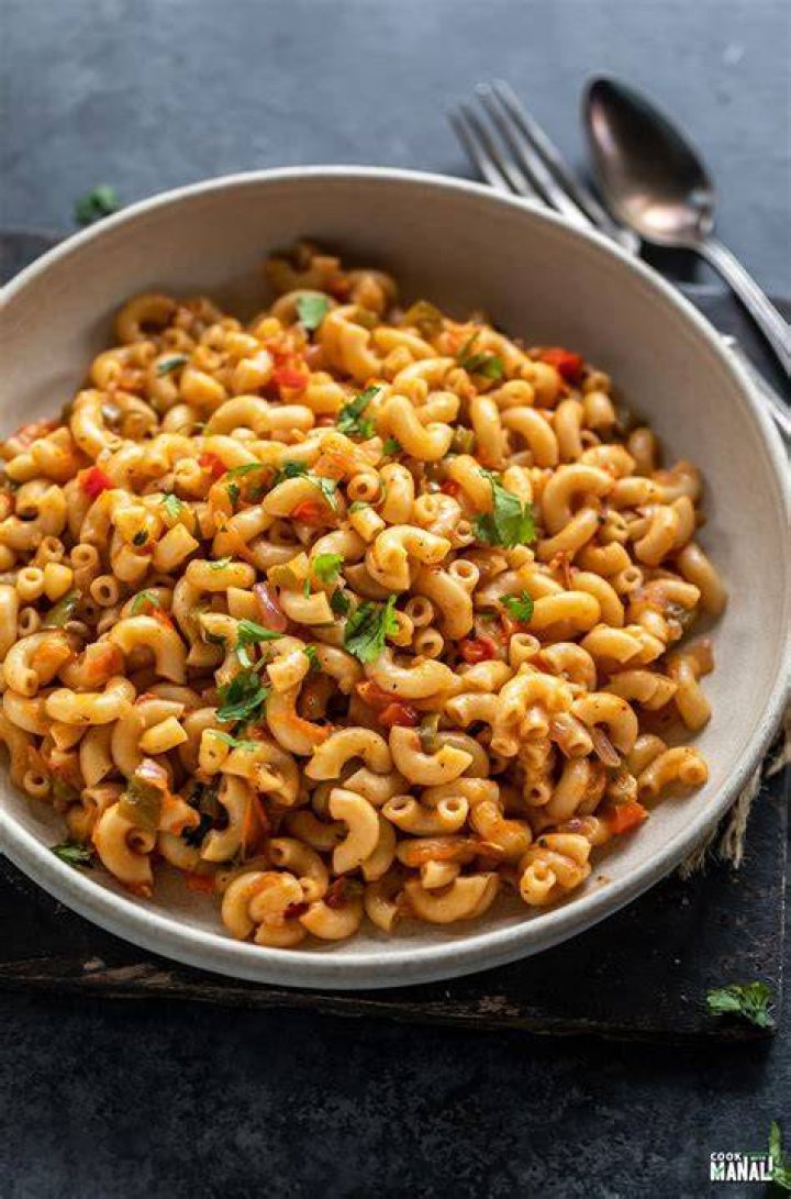 Pot of macaroni pasta with white cheese sauce poured in. 