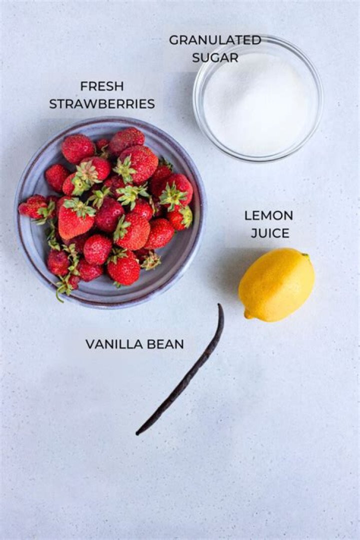 Strawberries, sugar and vanilla bean in a baking dish.